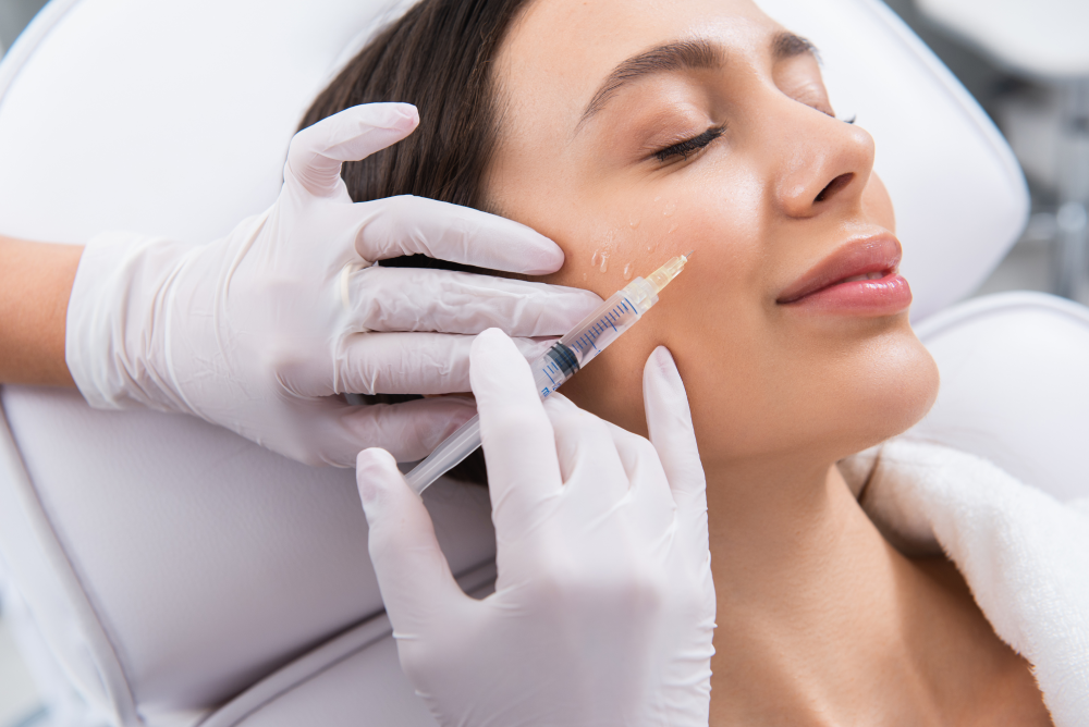 Dermal fillers session with an injector treating a woman’s cheek.