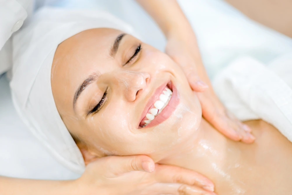 Woman enjoying a luxurious facial treatment at a spa.