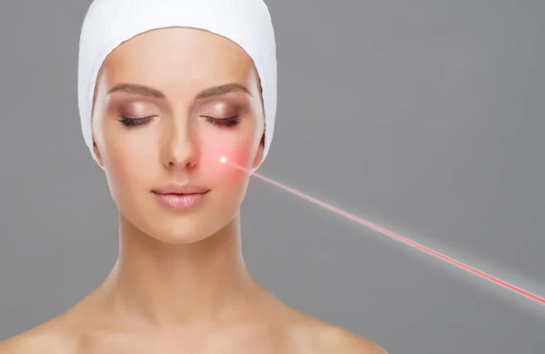 Person wearing a head wrap receives a facial laser treatment illustrated by a red light on the cheek.
